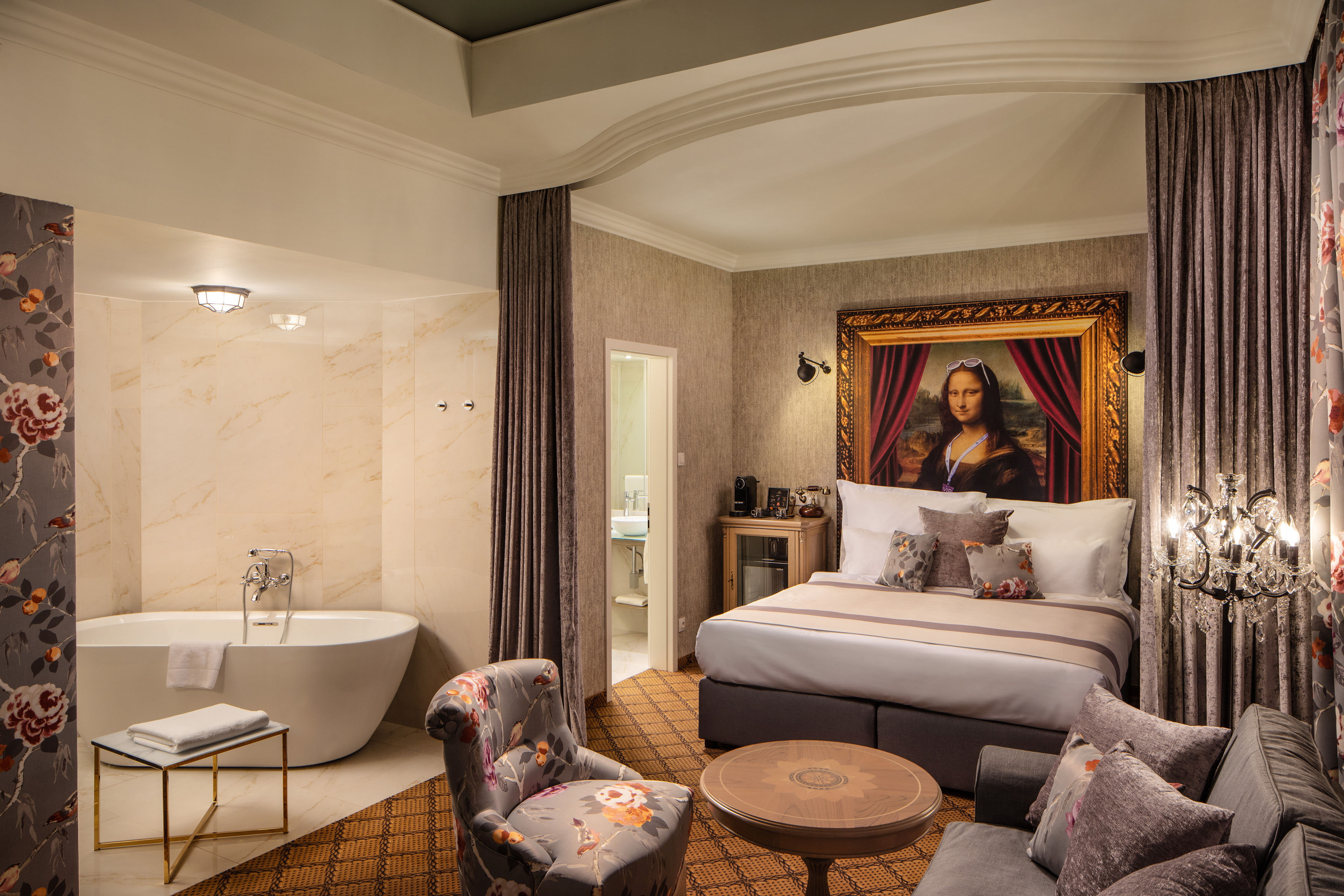 a room with a bed and a tub and a picture of a mona lisa