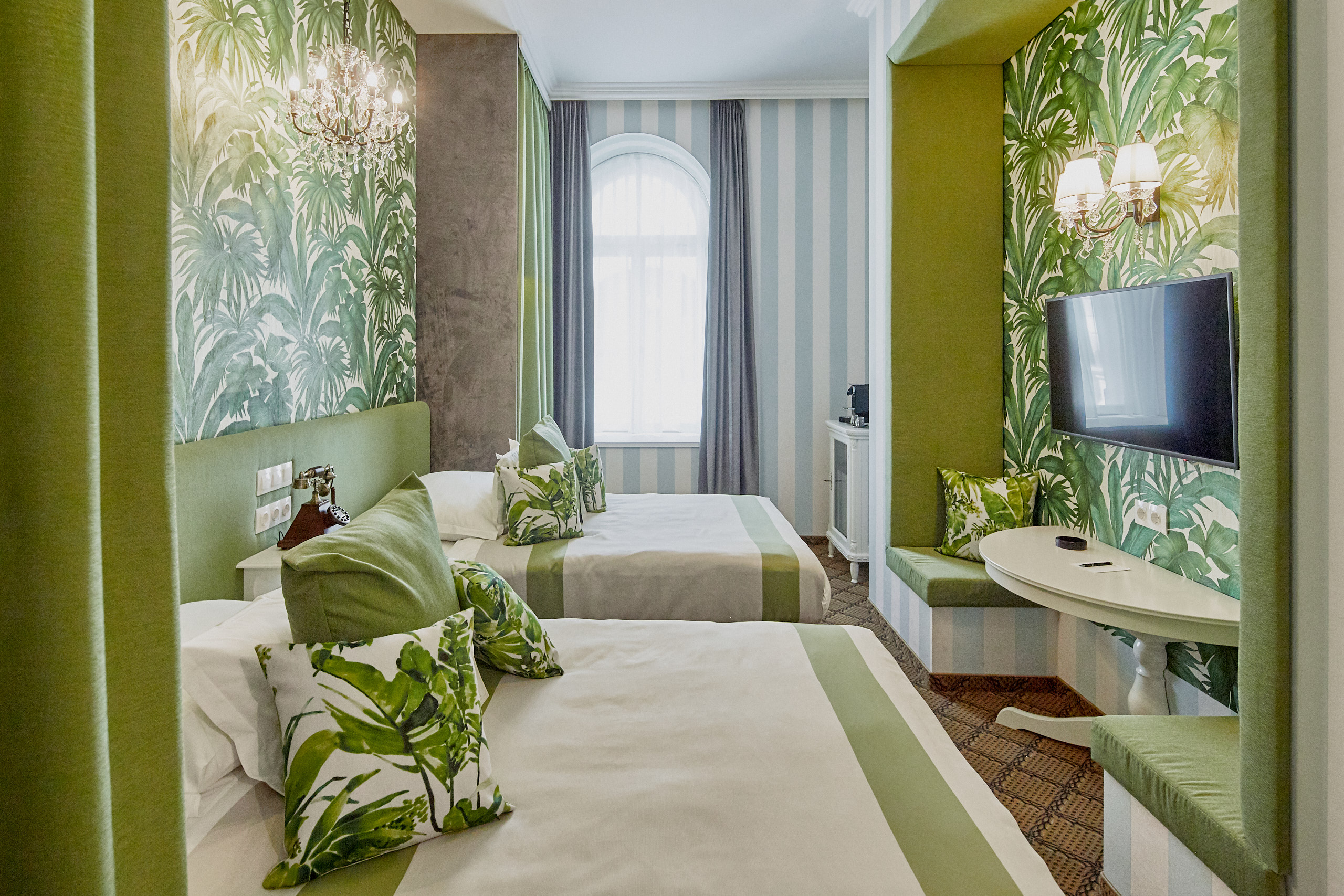 a room with two beds and a television