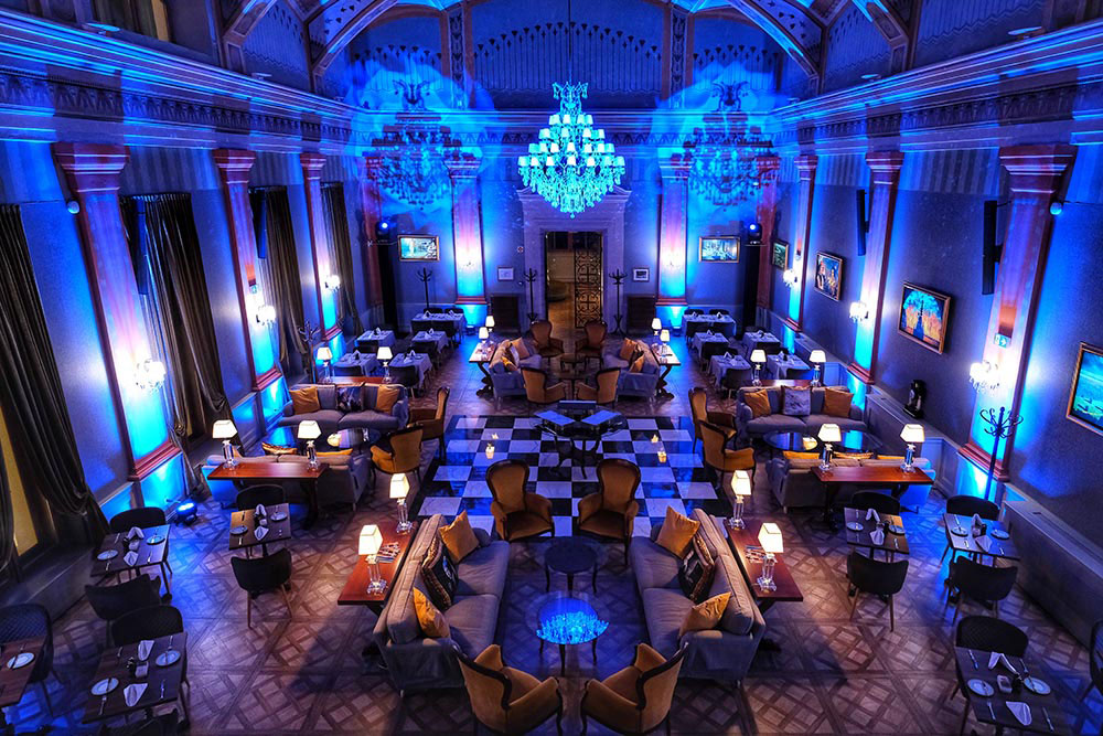 a room with a chandelier and tables