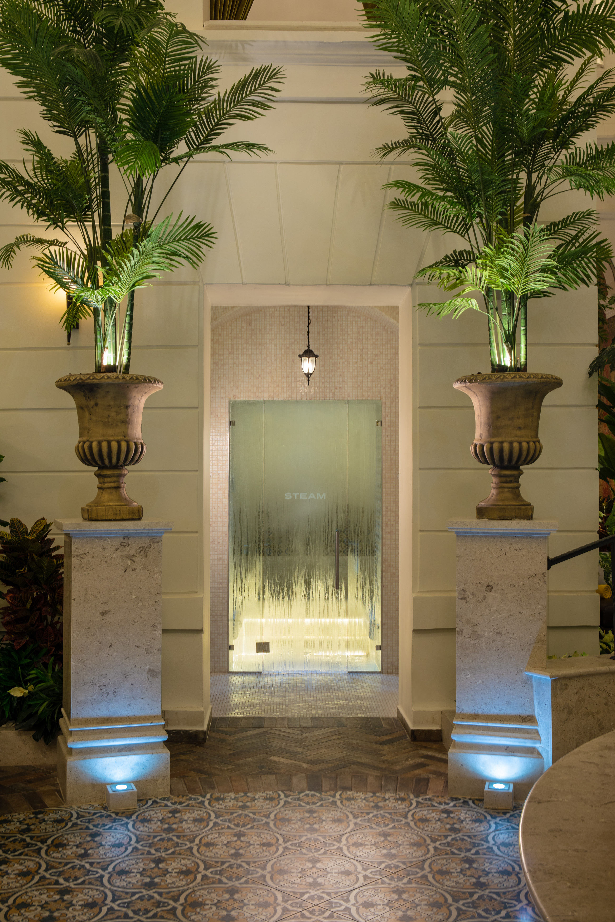 a building with a glass door and plants