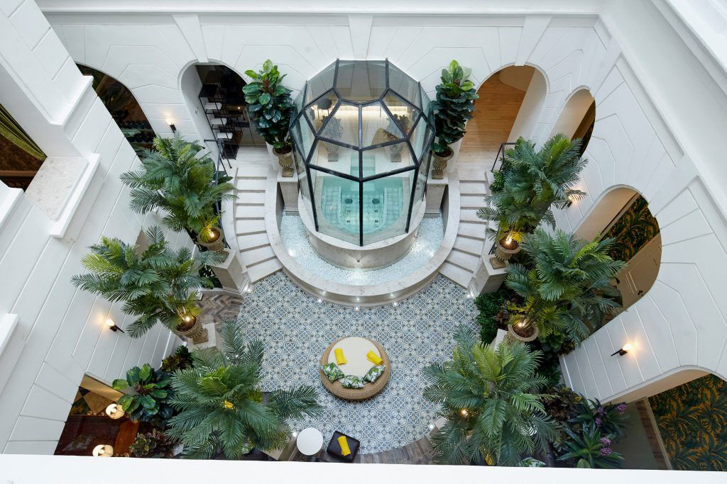 a glass room with a round glass tower and a round staircase