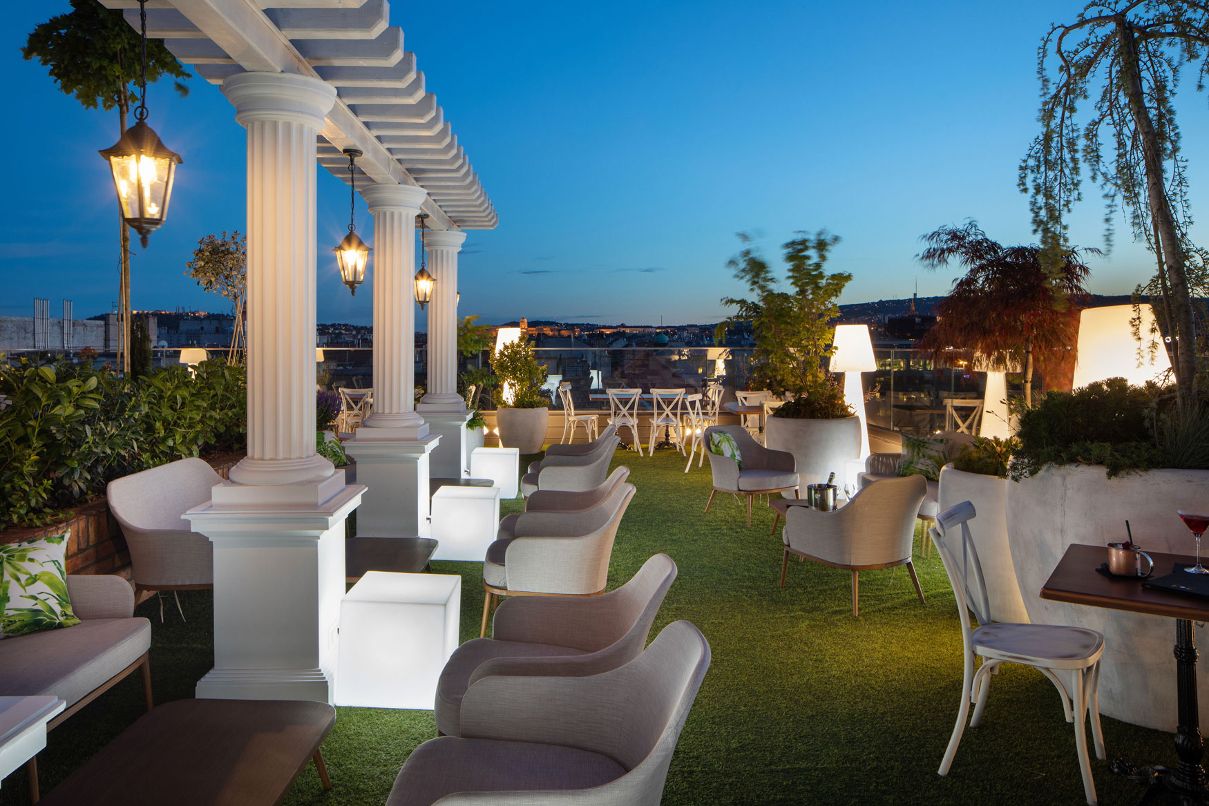 a patio with white chairs and tables