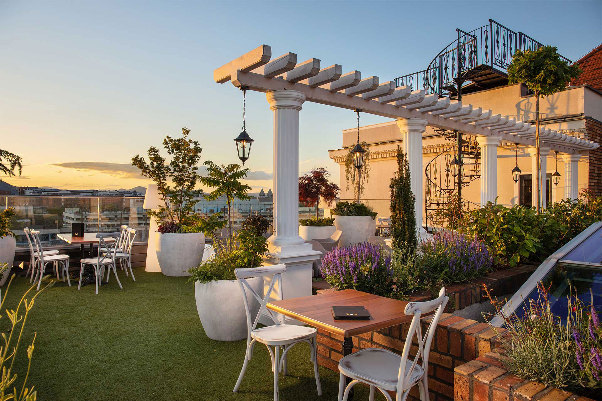 a patio with a pergola and chairs