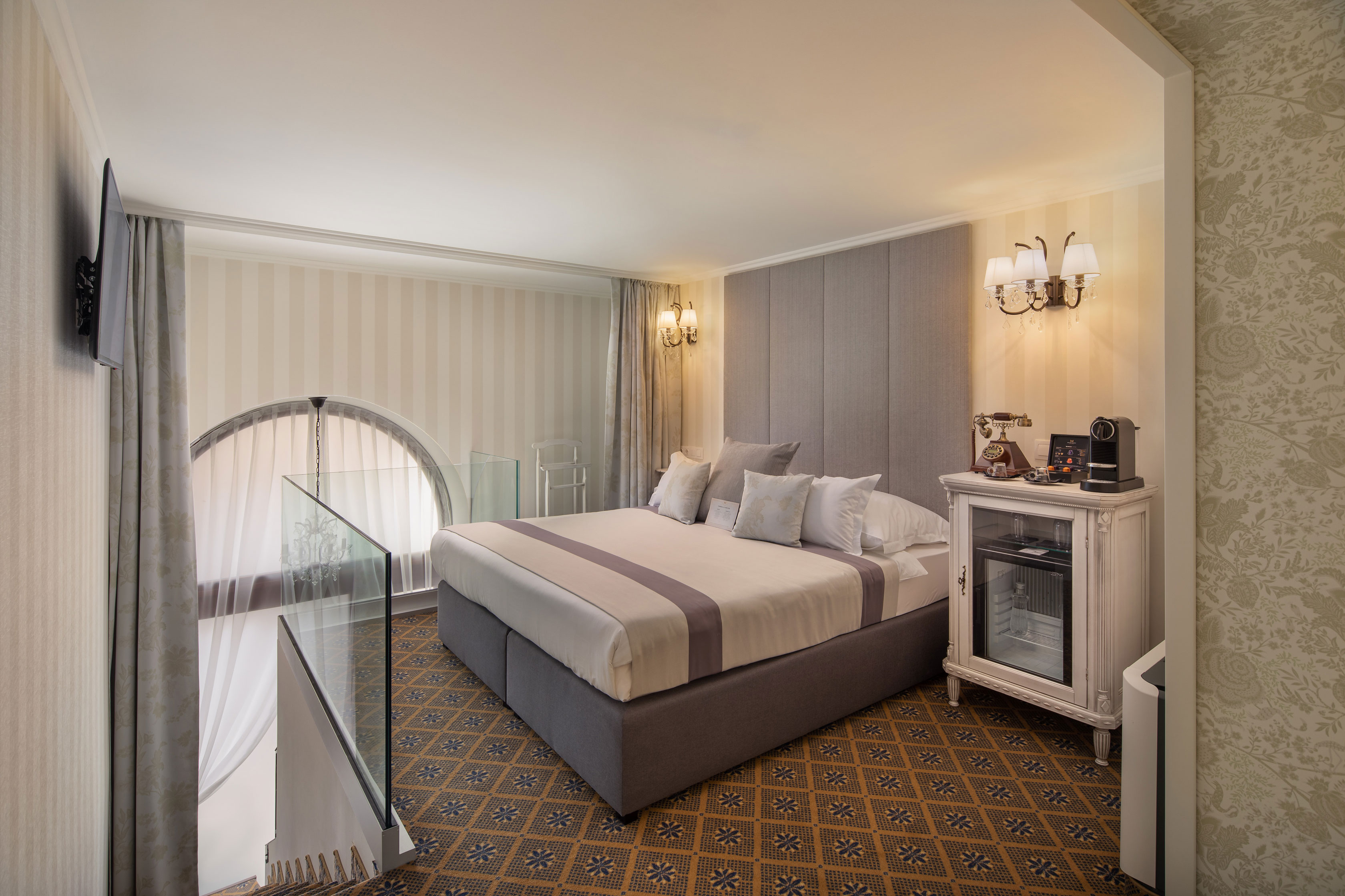 a bedroom with a bed and a glass railing
