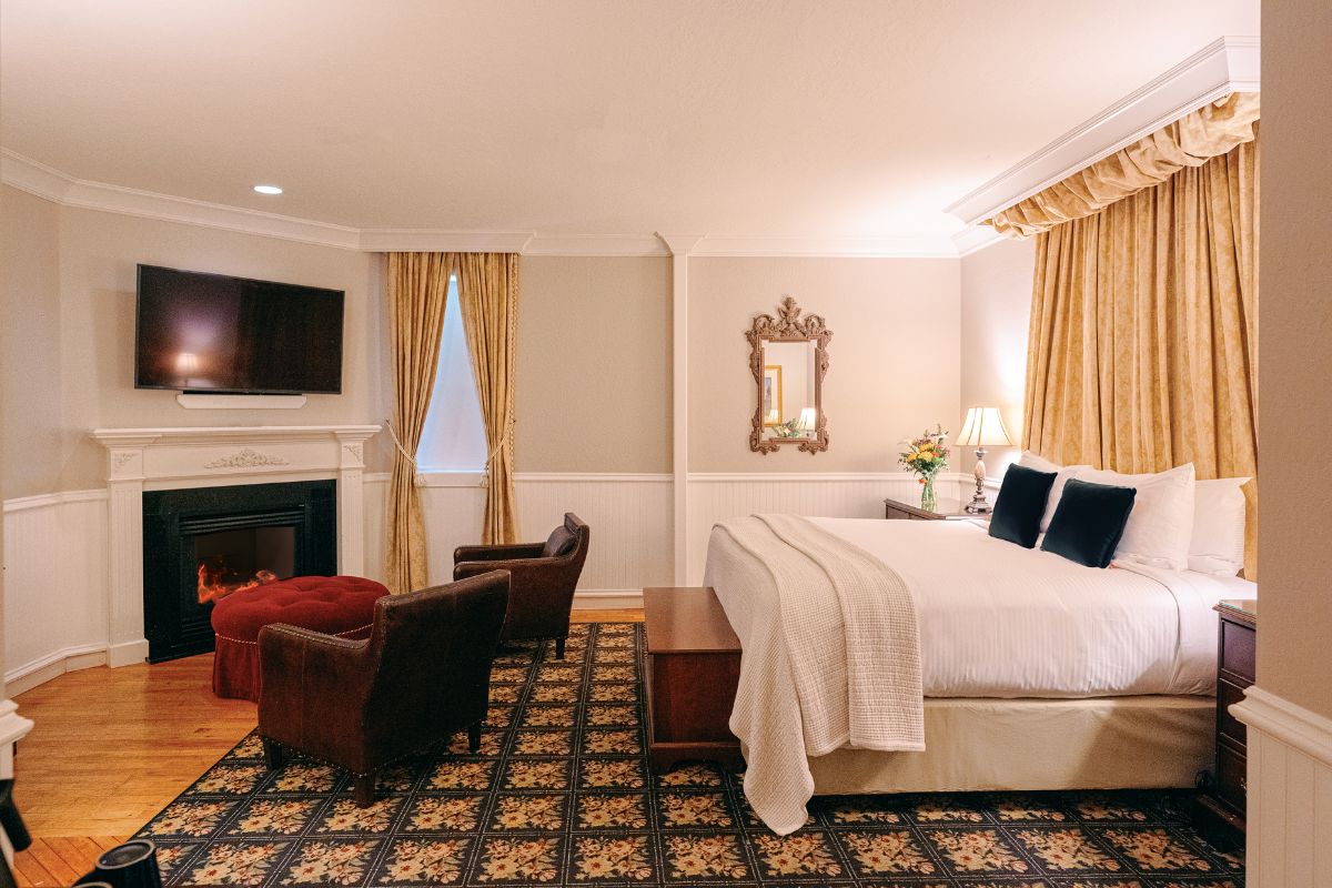 a room with a bed and a fireplace