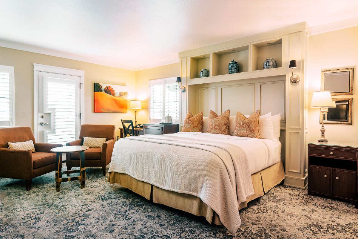 a bedroom with a bed and a chair