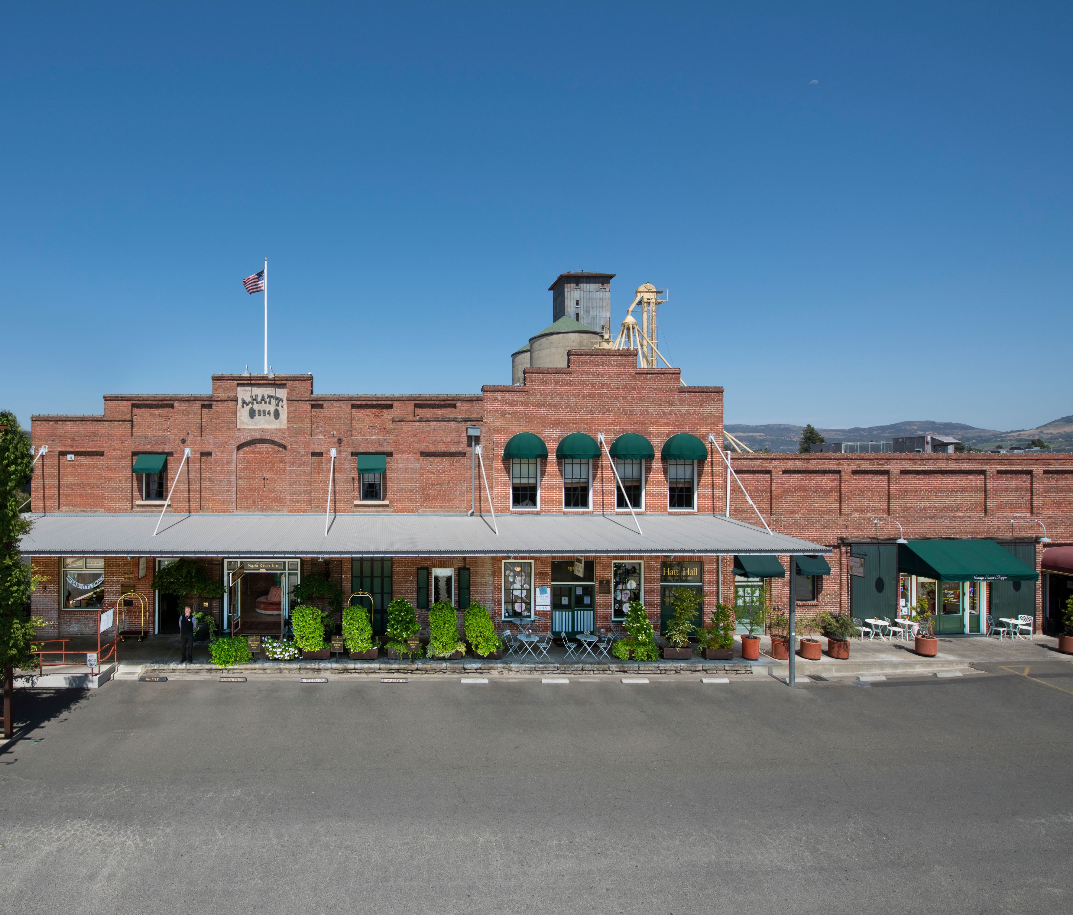 a brick building with a large parking lot