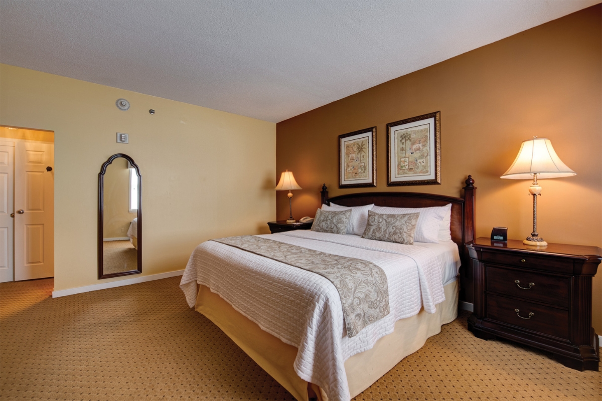 a bedroom with a bed and a mirror