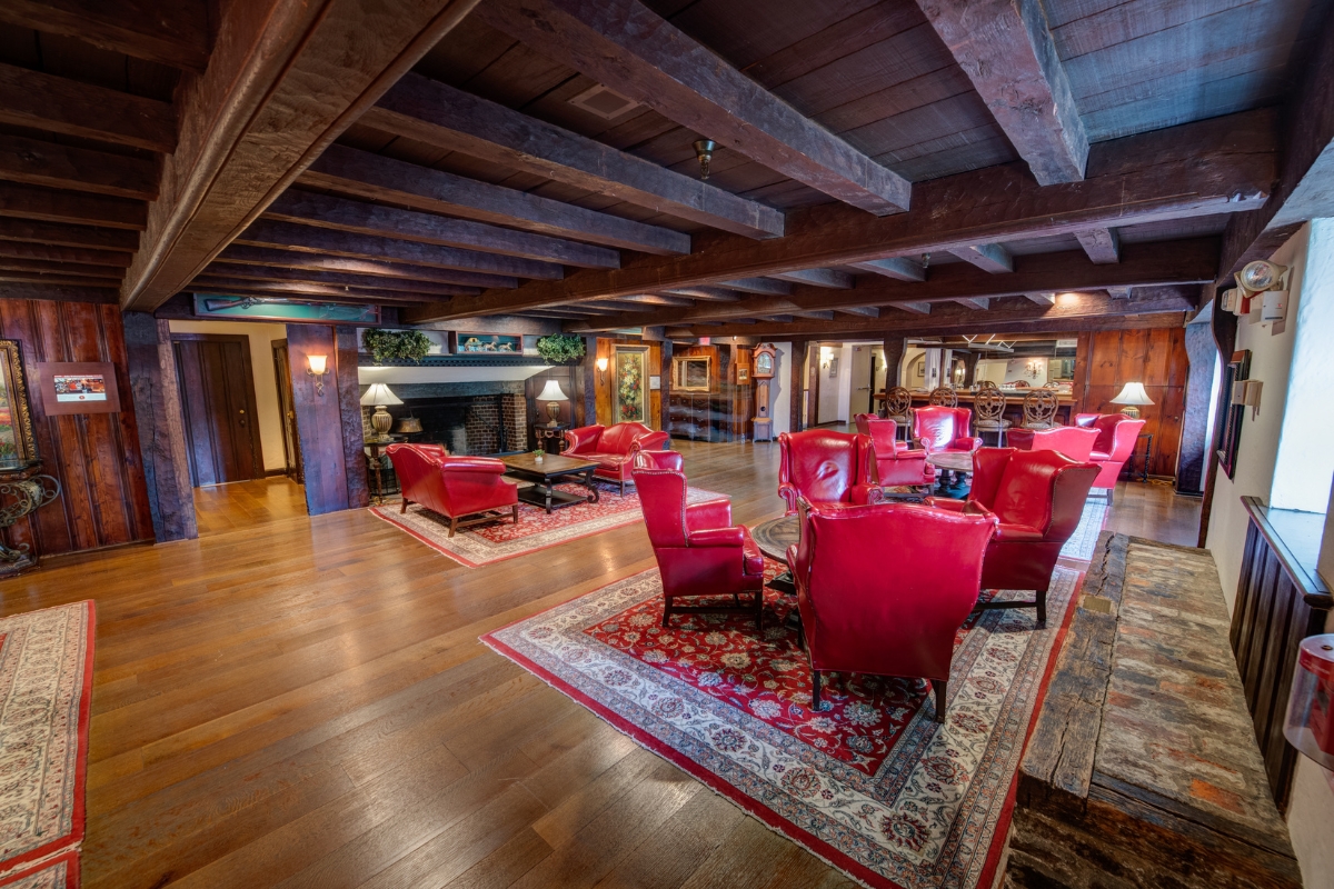 a room with red chairs and a rug