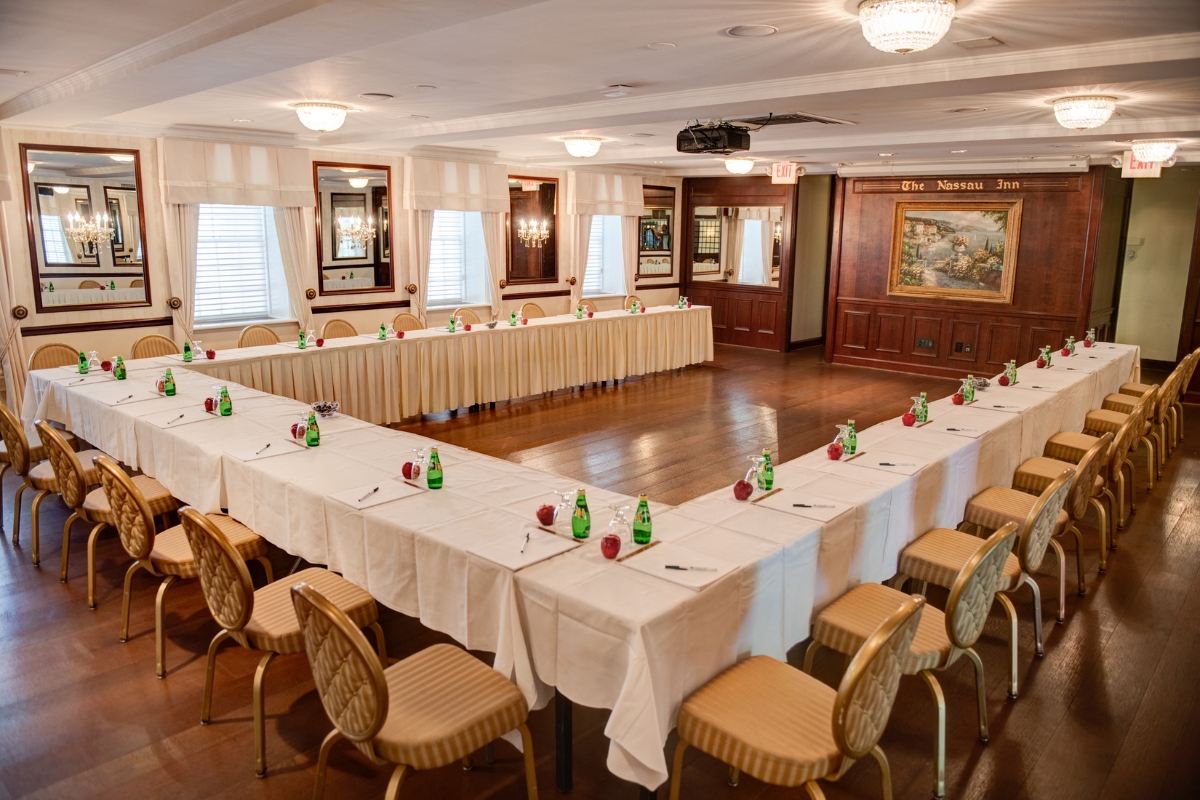 a long table with white cloths and bottles on it