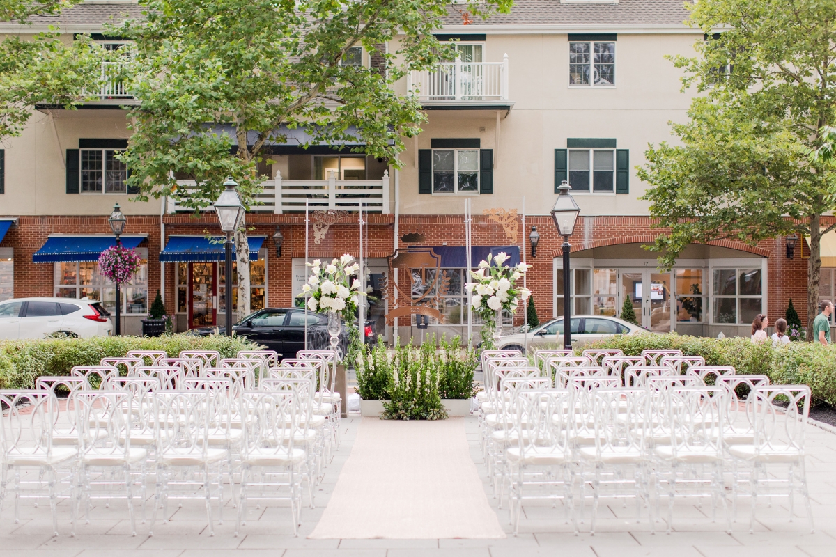 a wedding ceremony with chairs and flowers