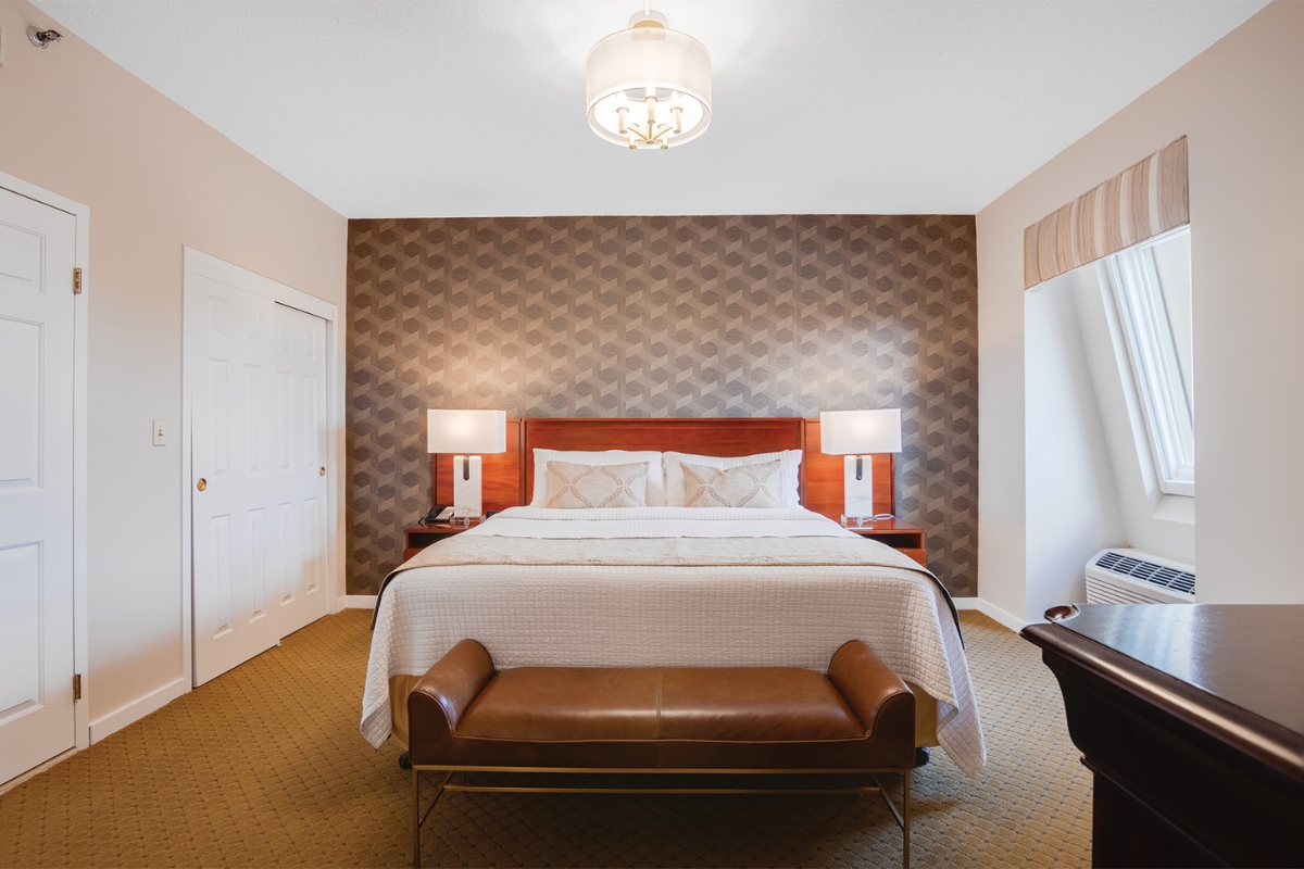 a bedroom with a bed and a bench