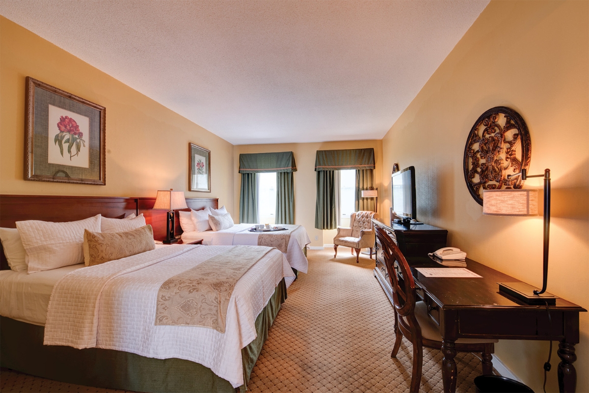a room with two beds and a television