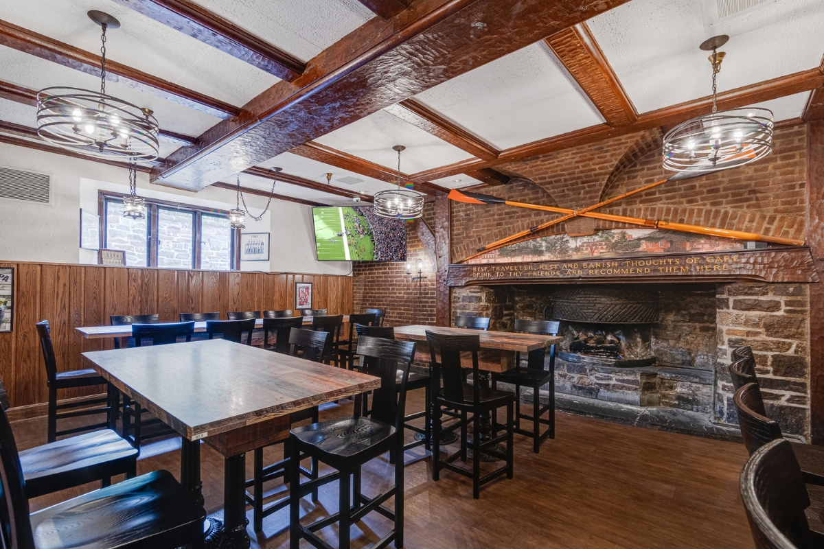 a room with tables and chairs and a fireplace