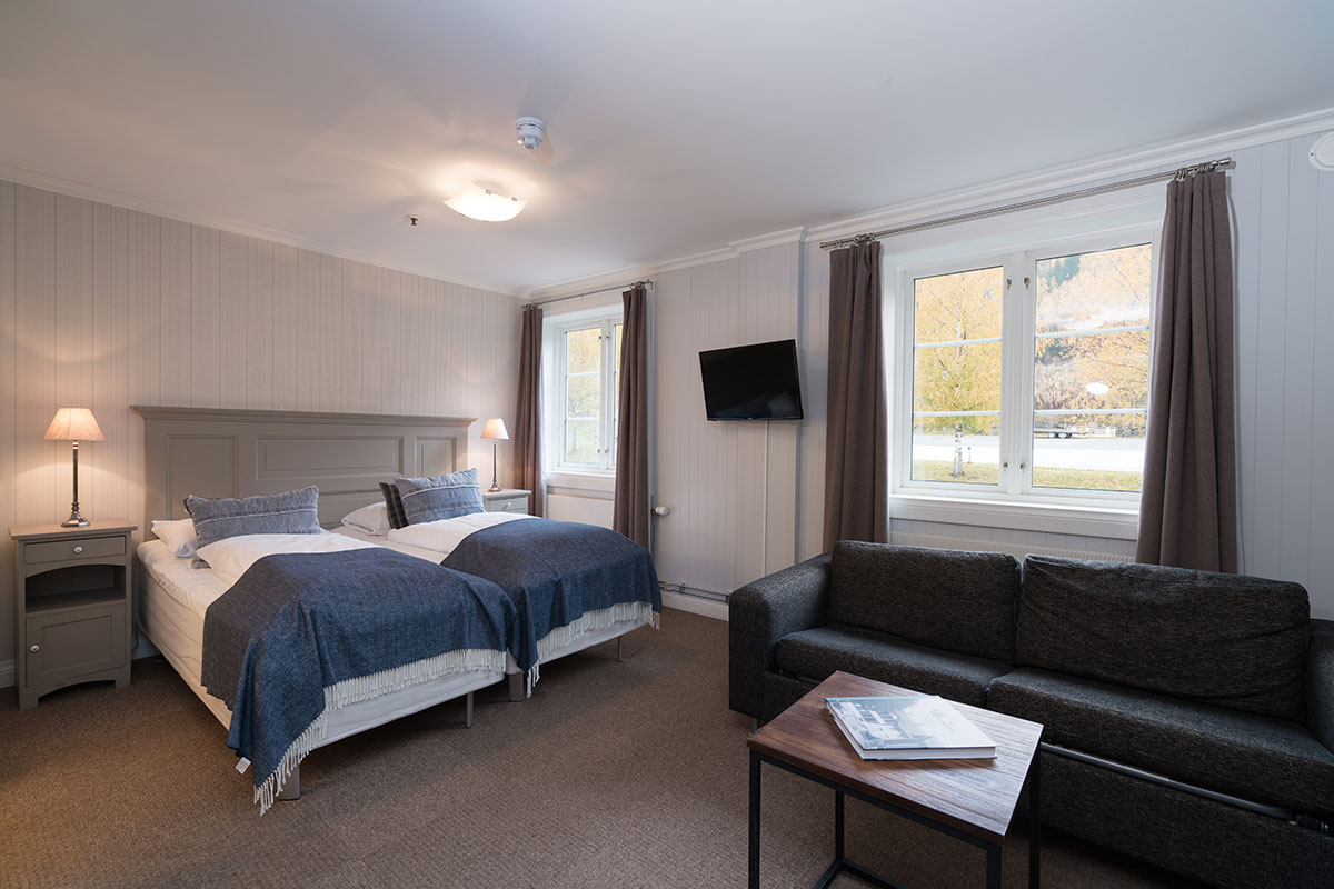 a room with two beds and a couch