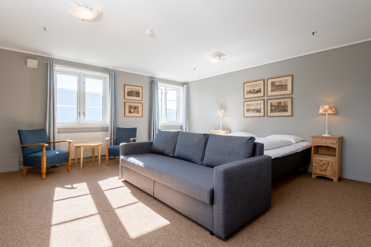 a room with a couch and two beds