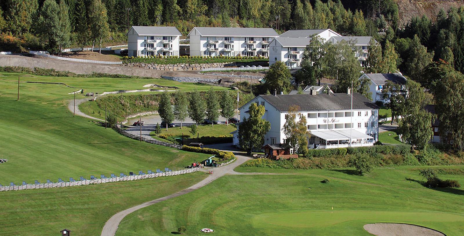 a golf course with several white buildings