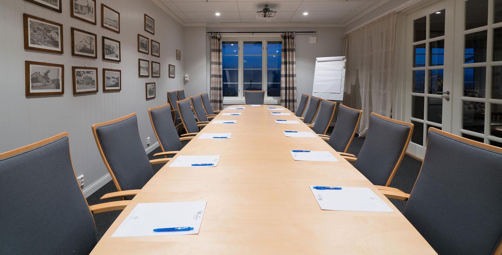 a conference room with a table and chairs