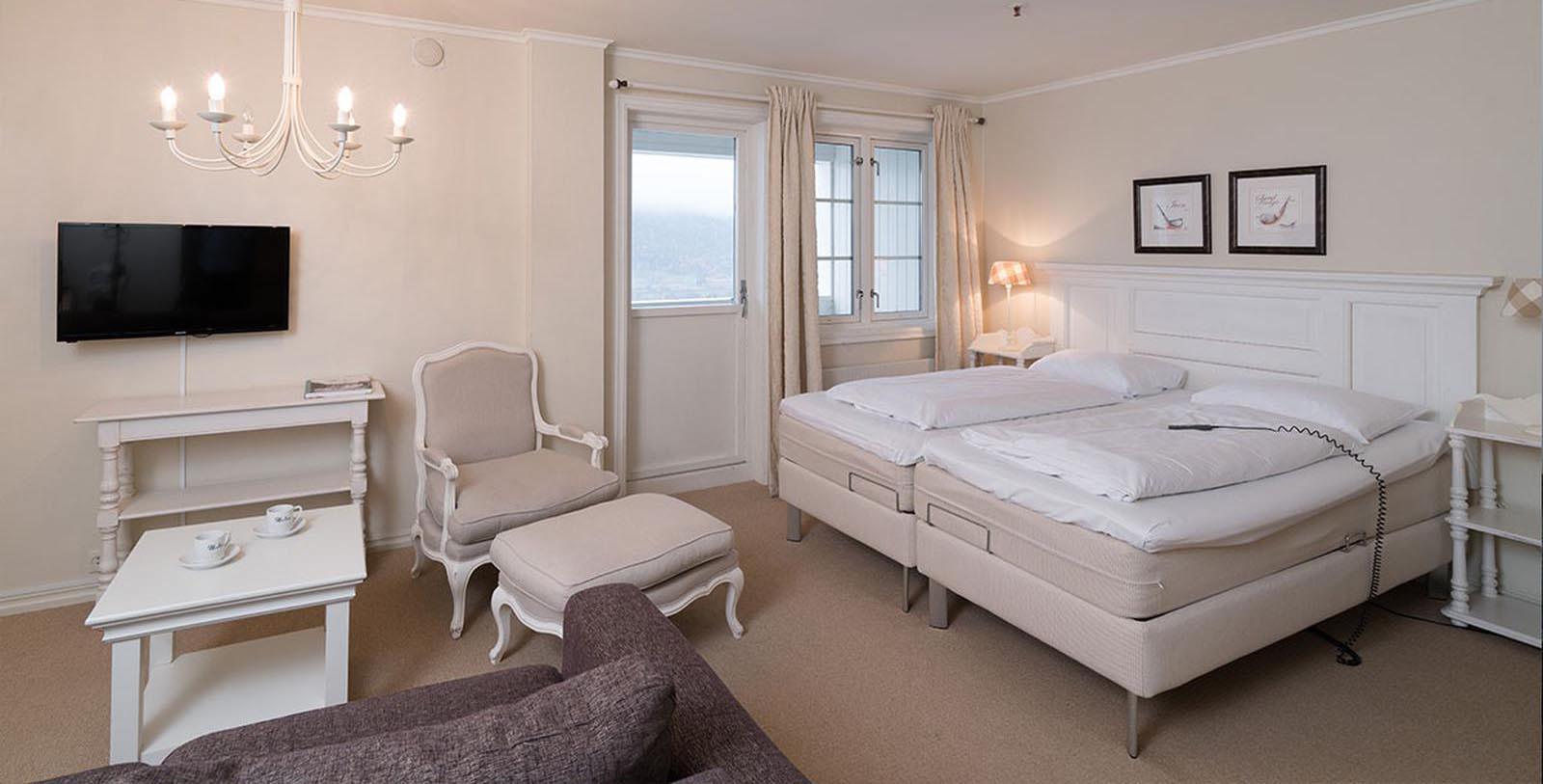 a room with two beds and a lamp