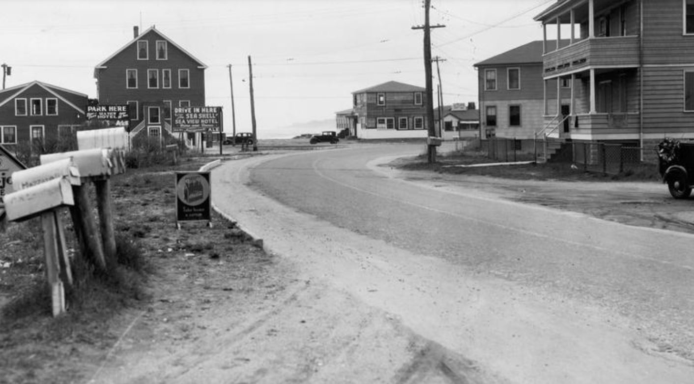 a road with houses and signs