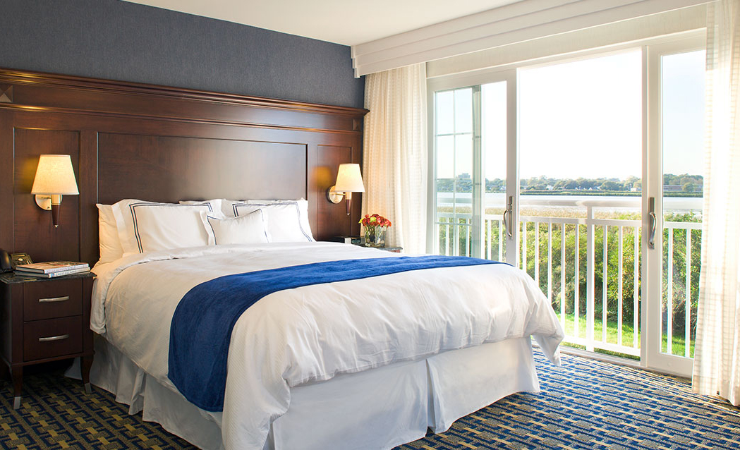 a bed with a wood headboard and a wood headboard with a wood headboard and a wood headboard with a blue and white blanket
