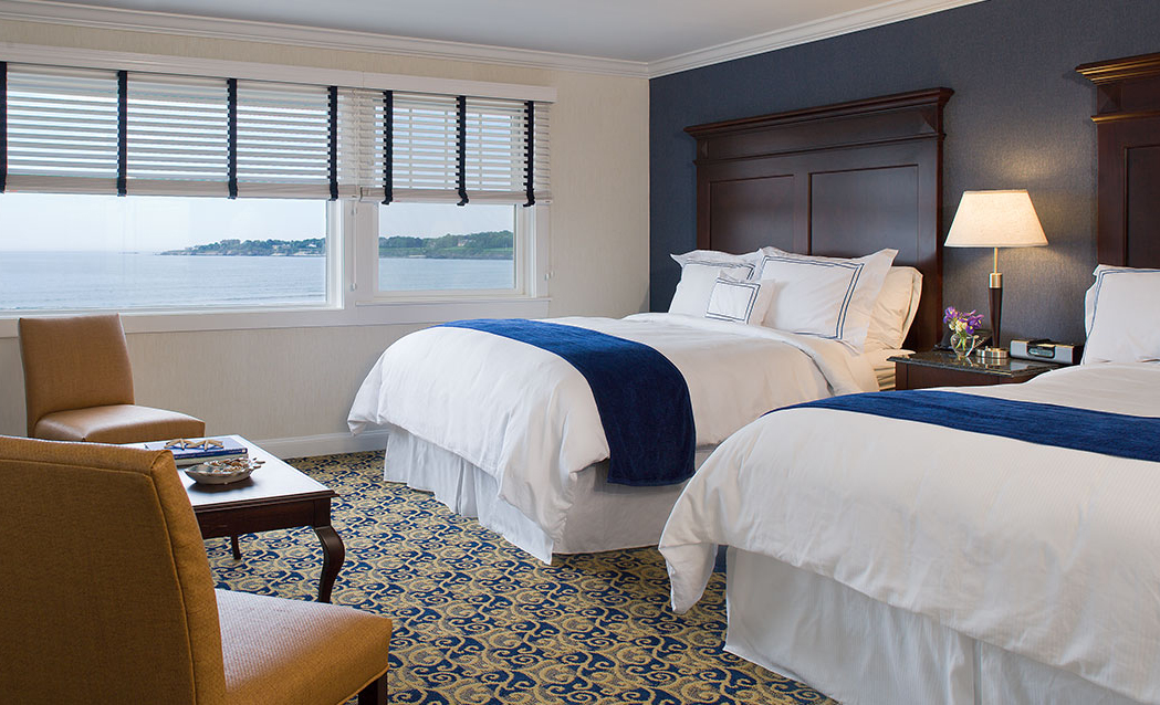 a room with two beds and a window