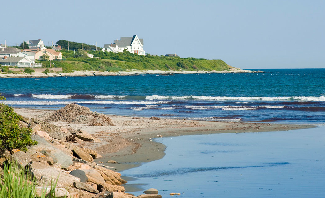 a beach with a house on the side