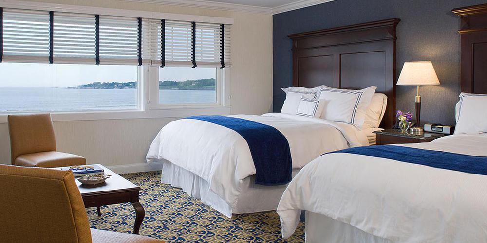 a room with two beds and a window