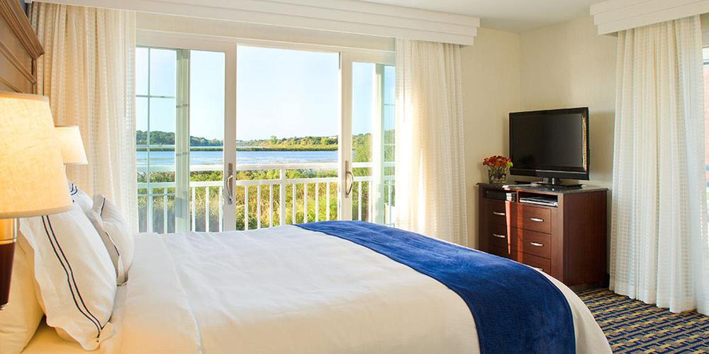 a bedroom with a large bed and a television