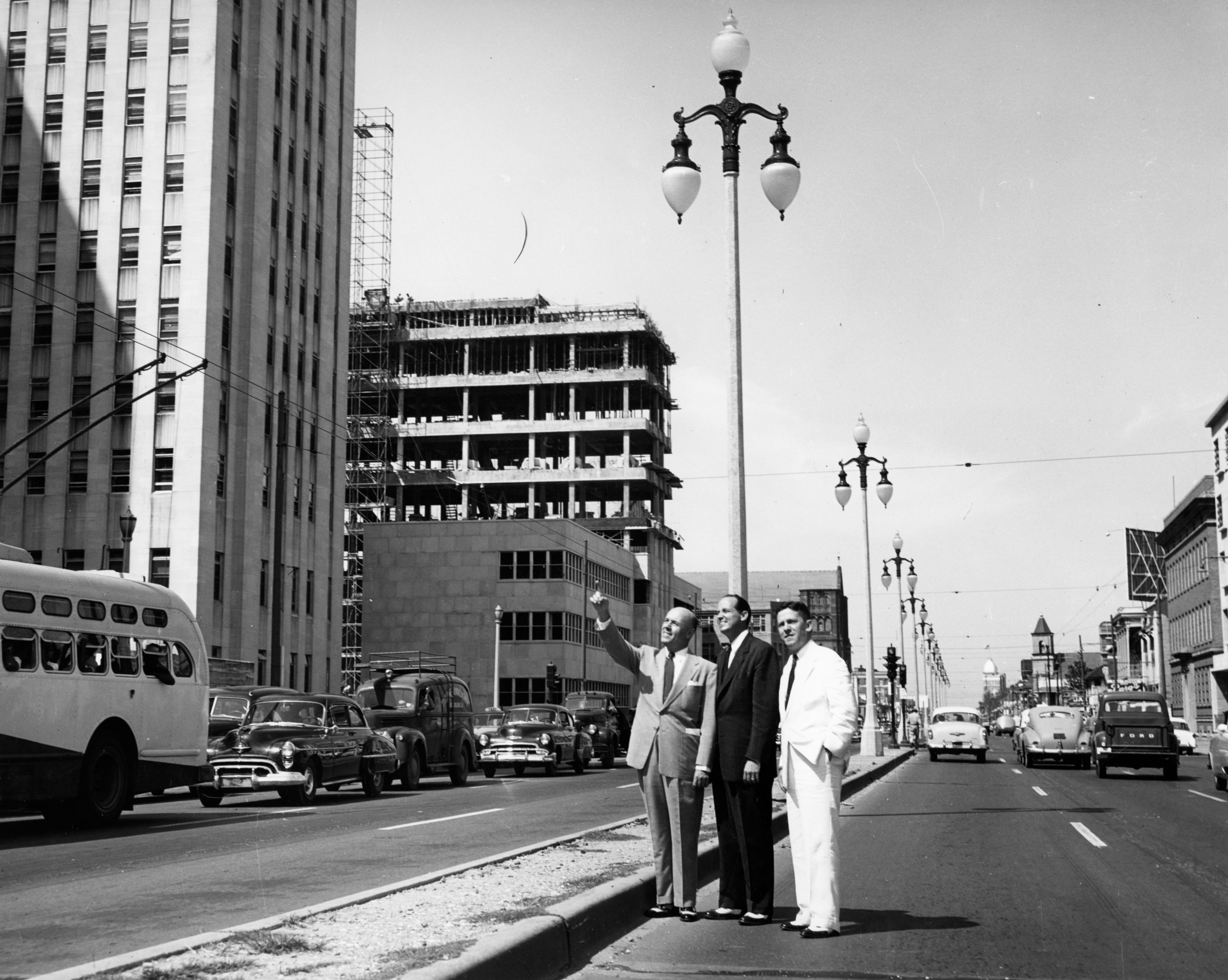 a group of men standing on the side of a road