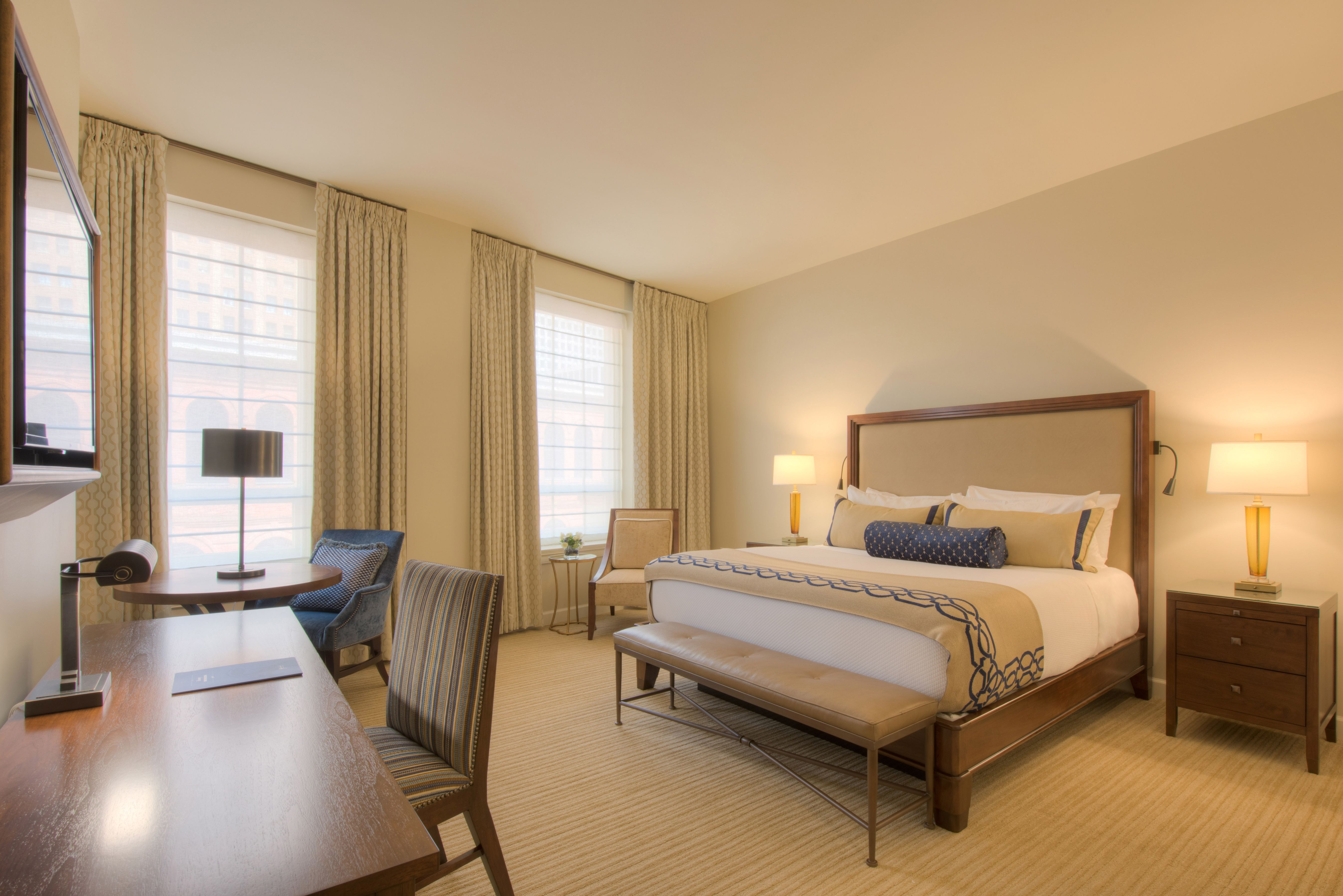 a bedroom with a bed and chairs