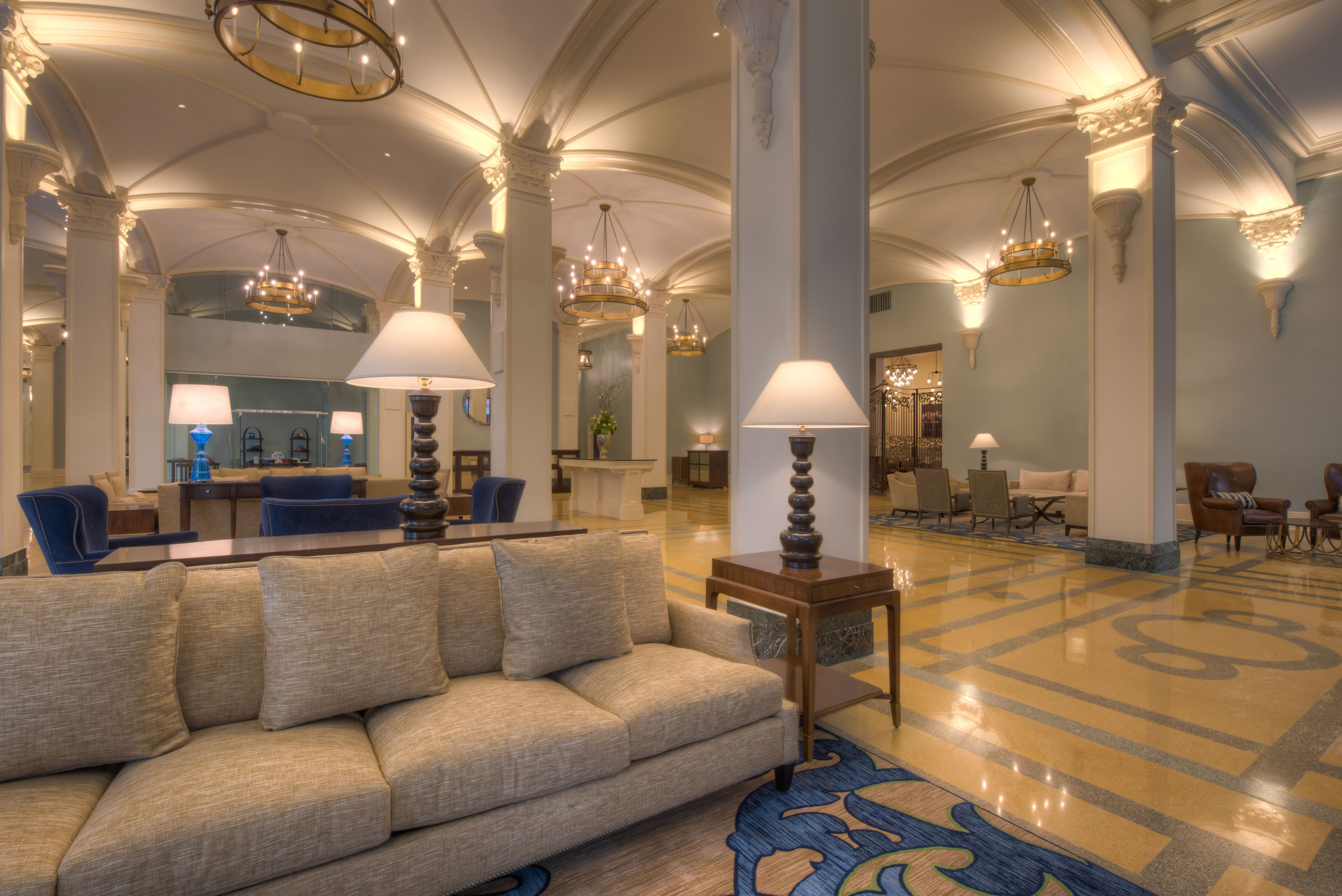 a large room with a couch and lamps