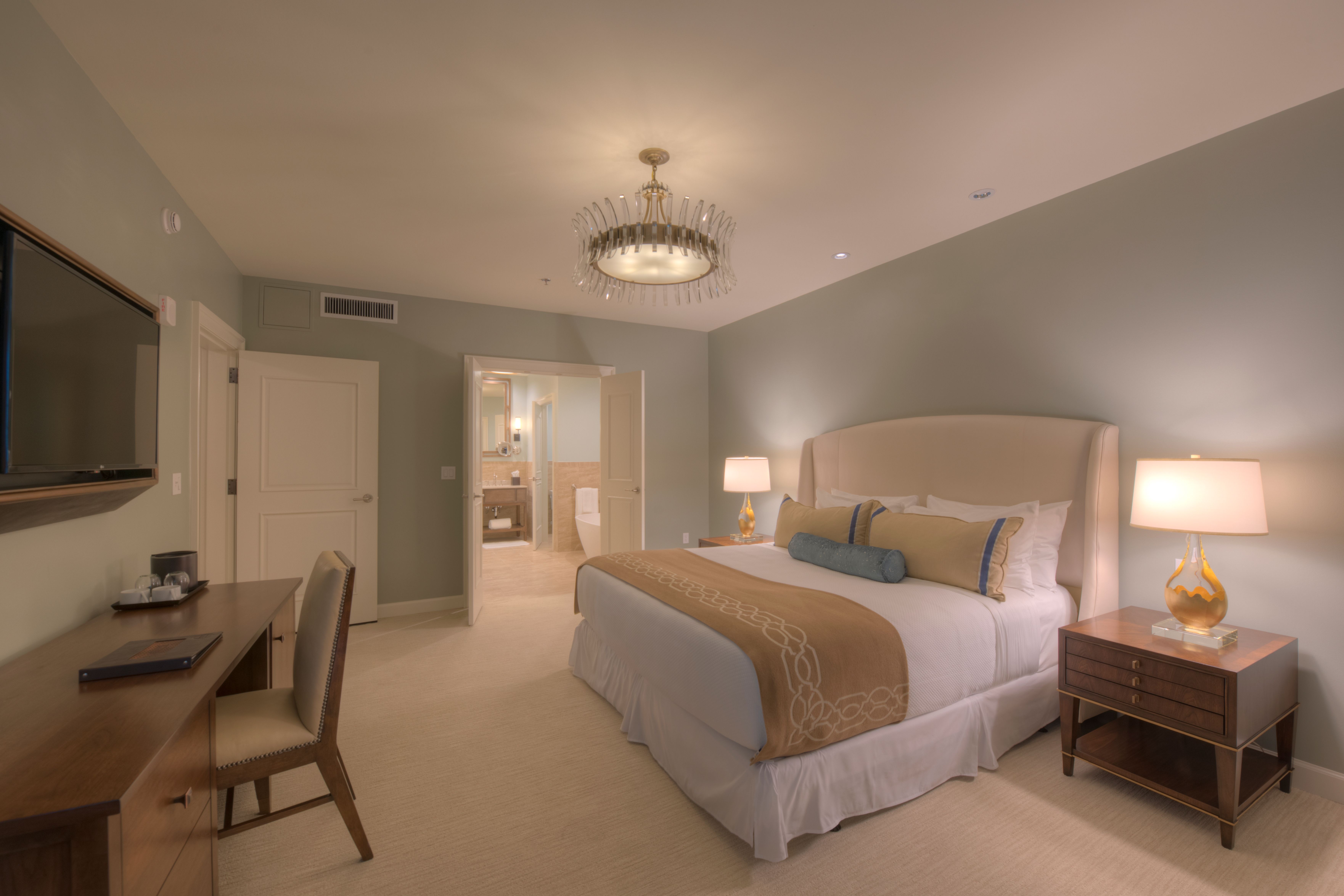 a bedroom with a bed and a table