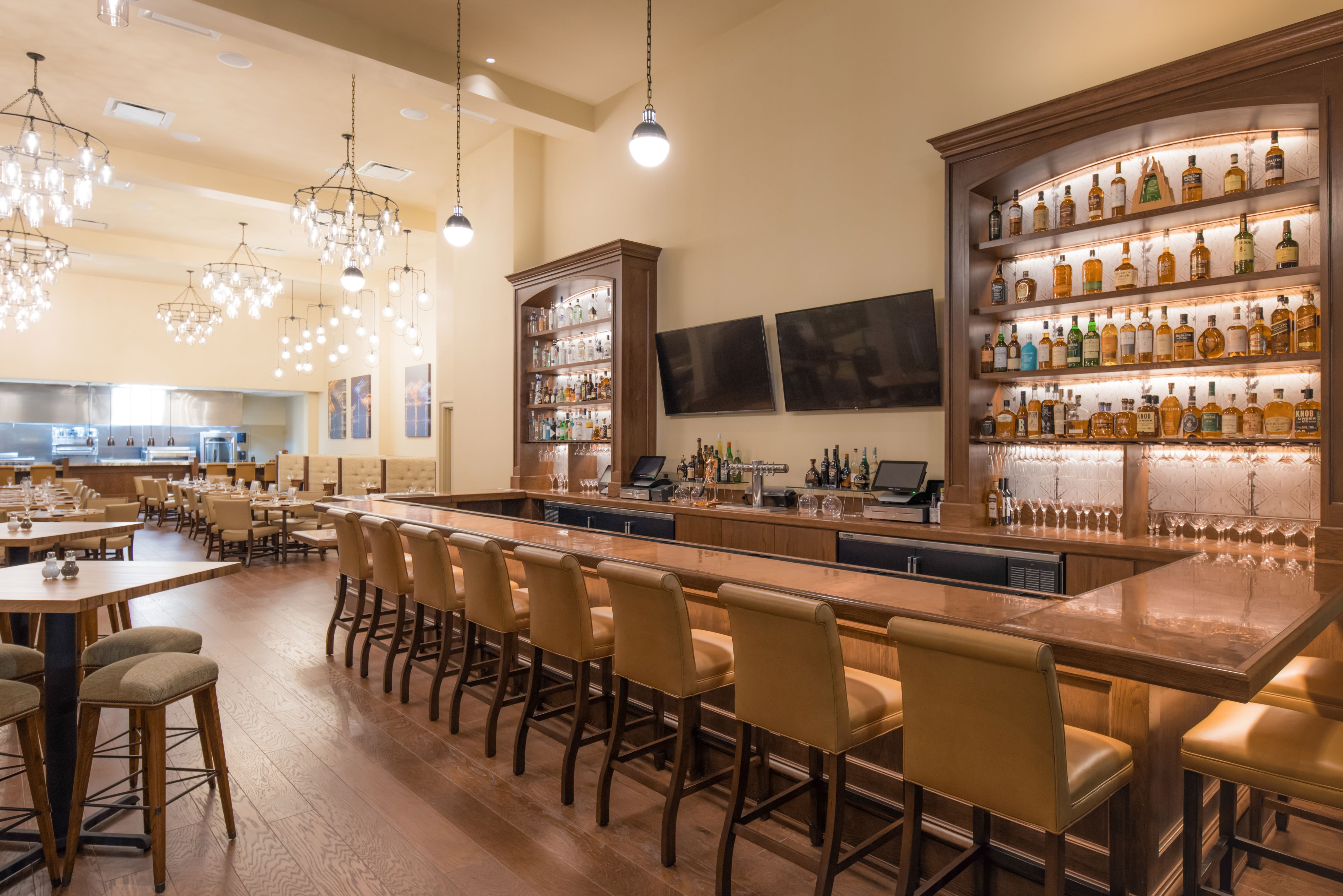 a bar with a row of chairs and a table