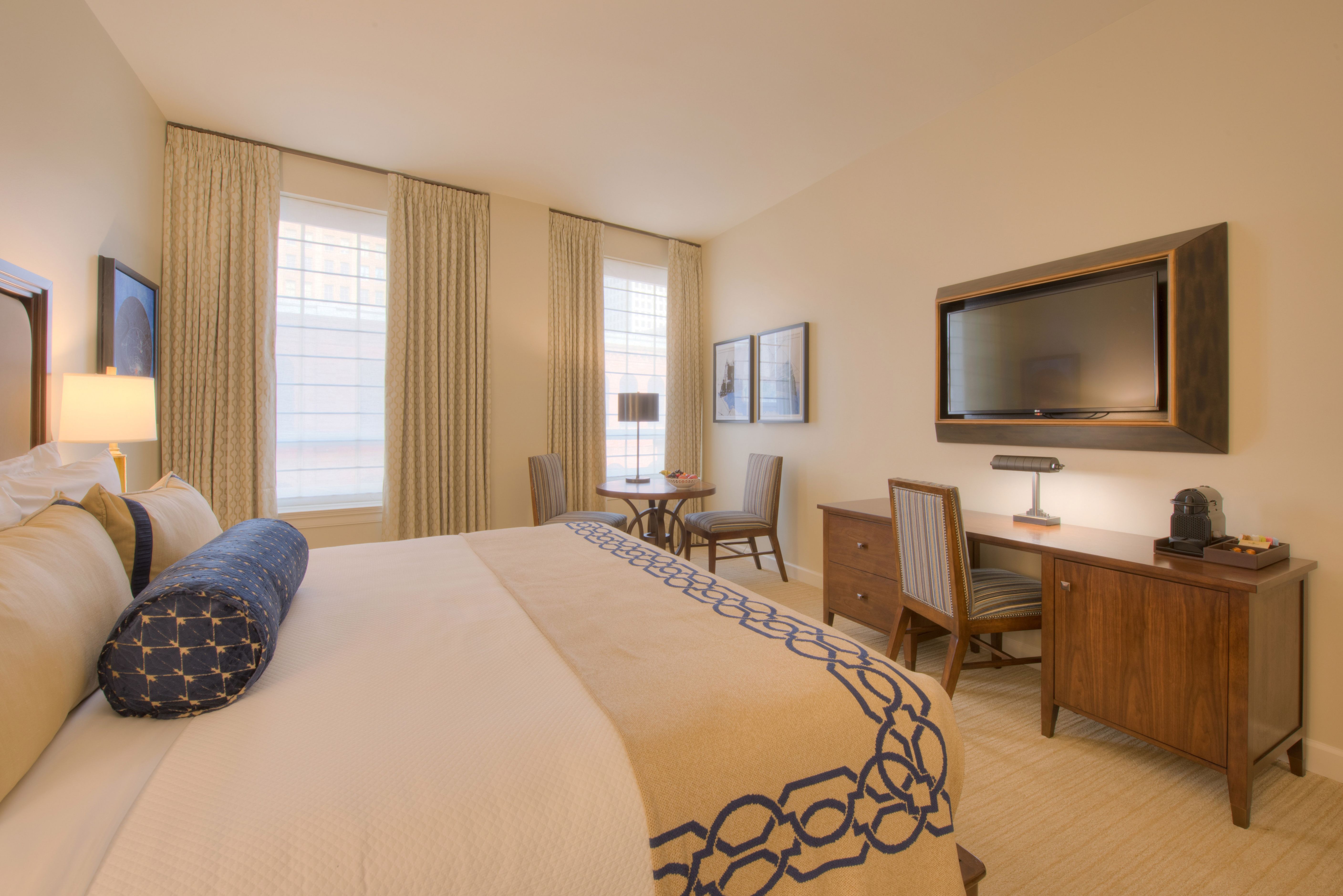 a room with a bed and a television