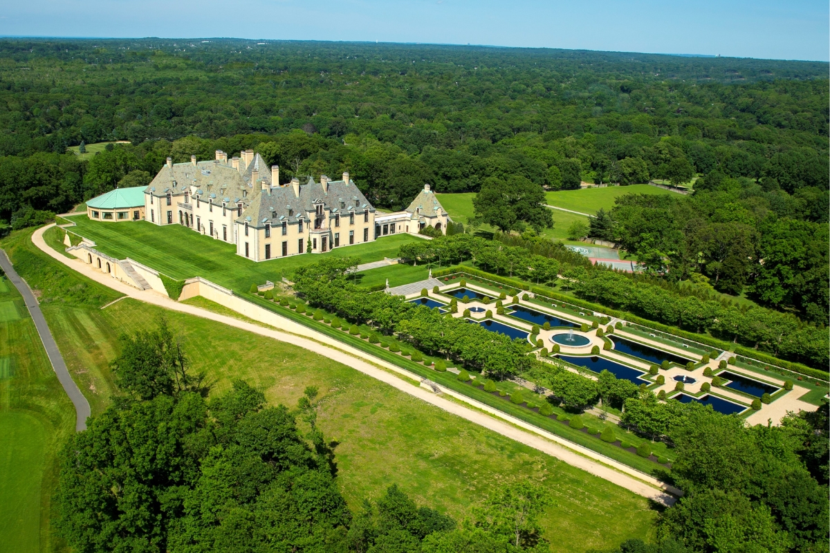 a large mansion with a large pool and trees
