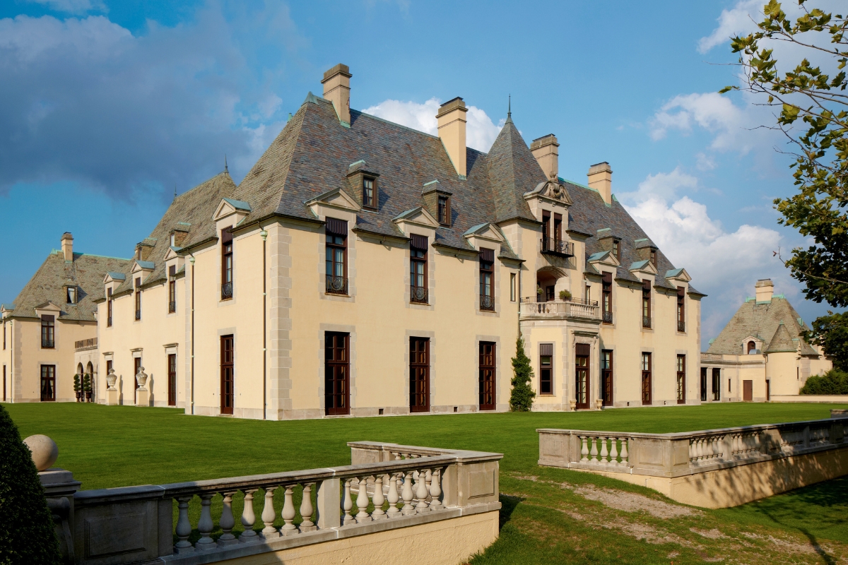 a large building with a lawn and a fence