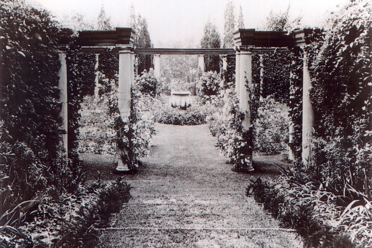 a path with pillars and a fountain