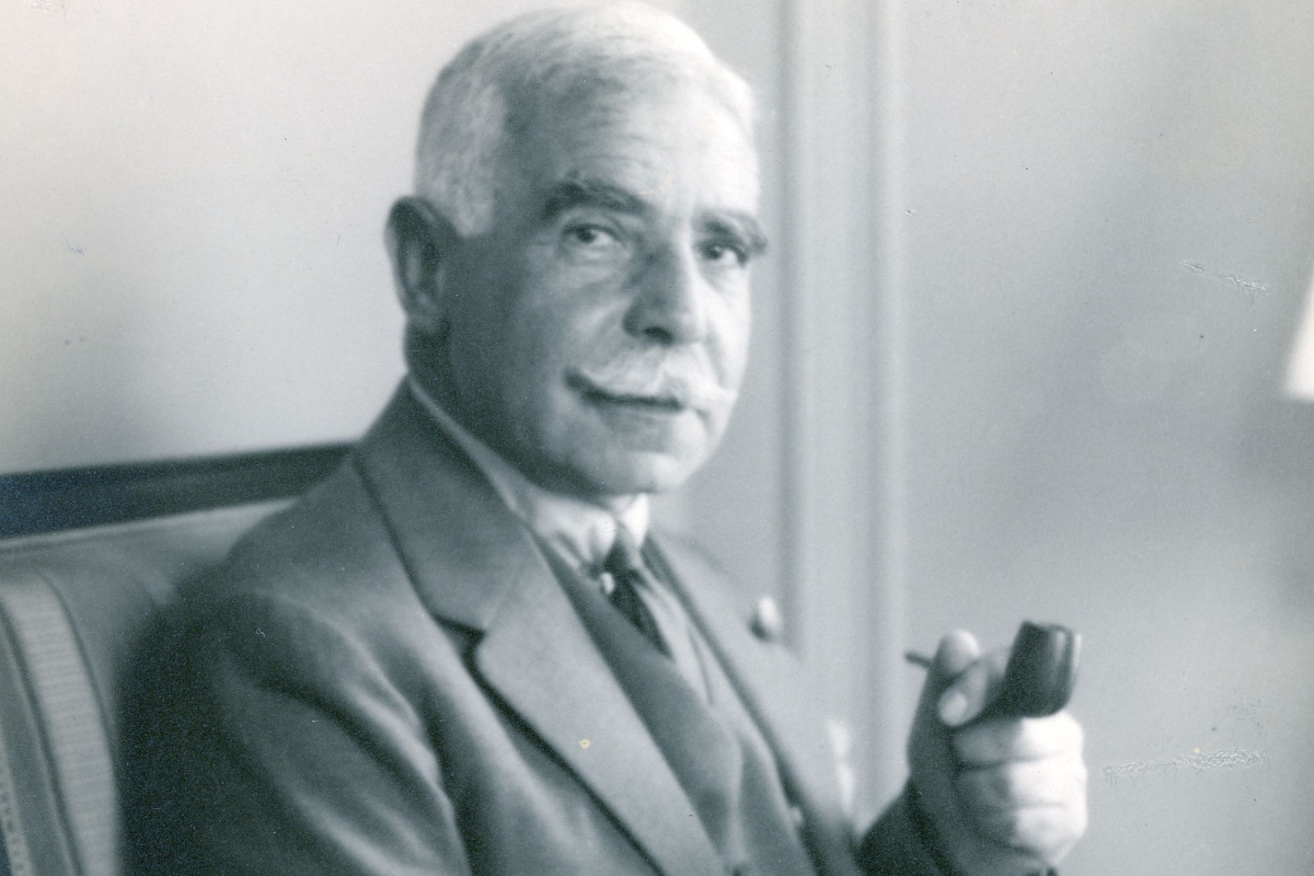 a man in a suit holding a pipe