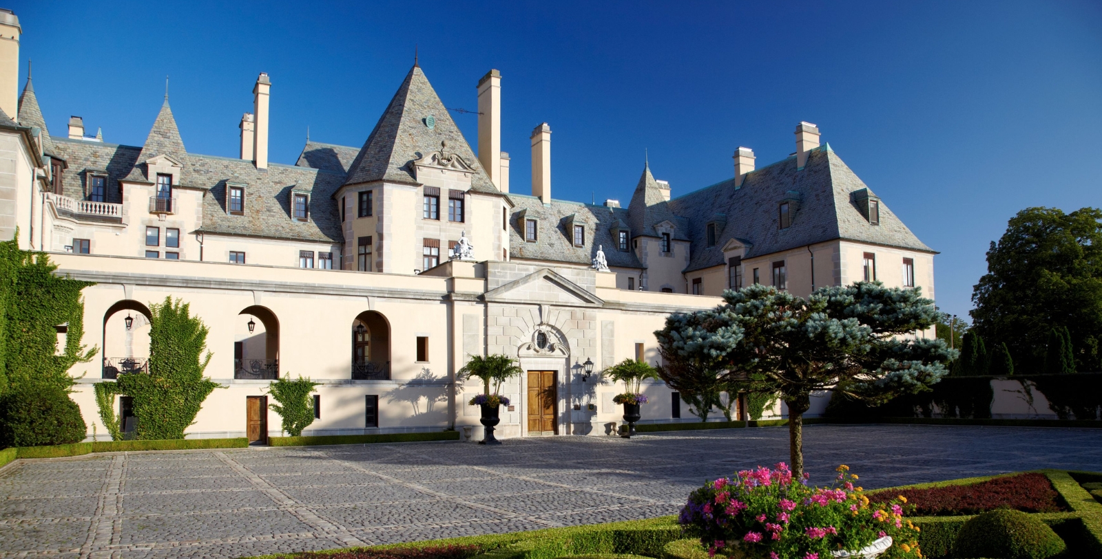 a large building with a stone driveway