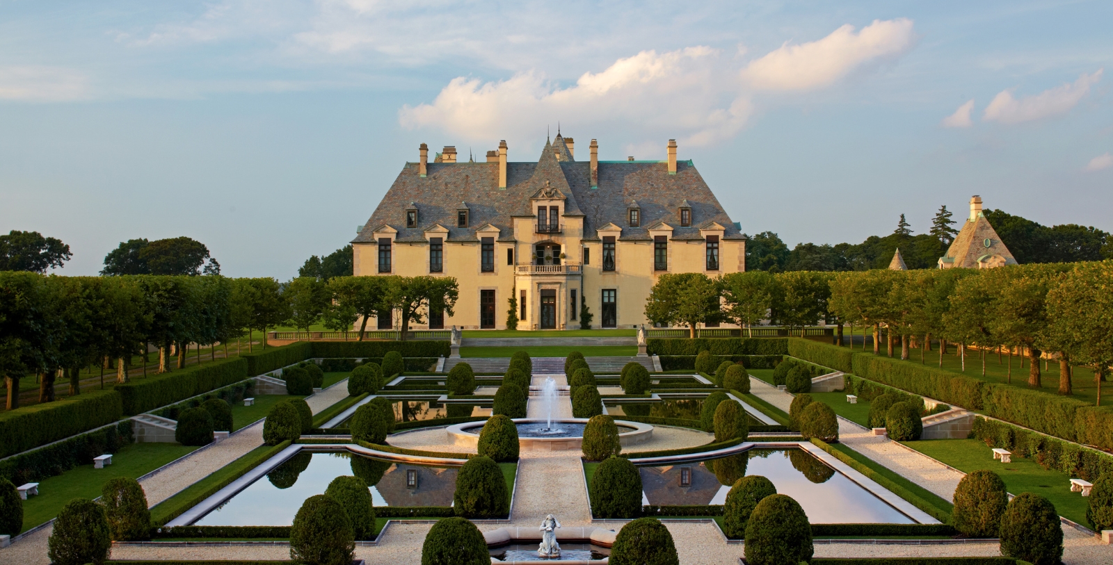 a large mansion with a fountain in front of it
