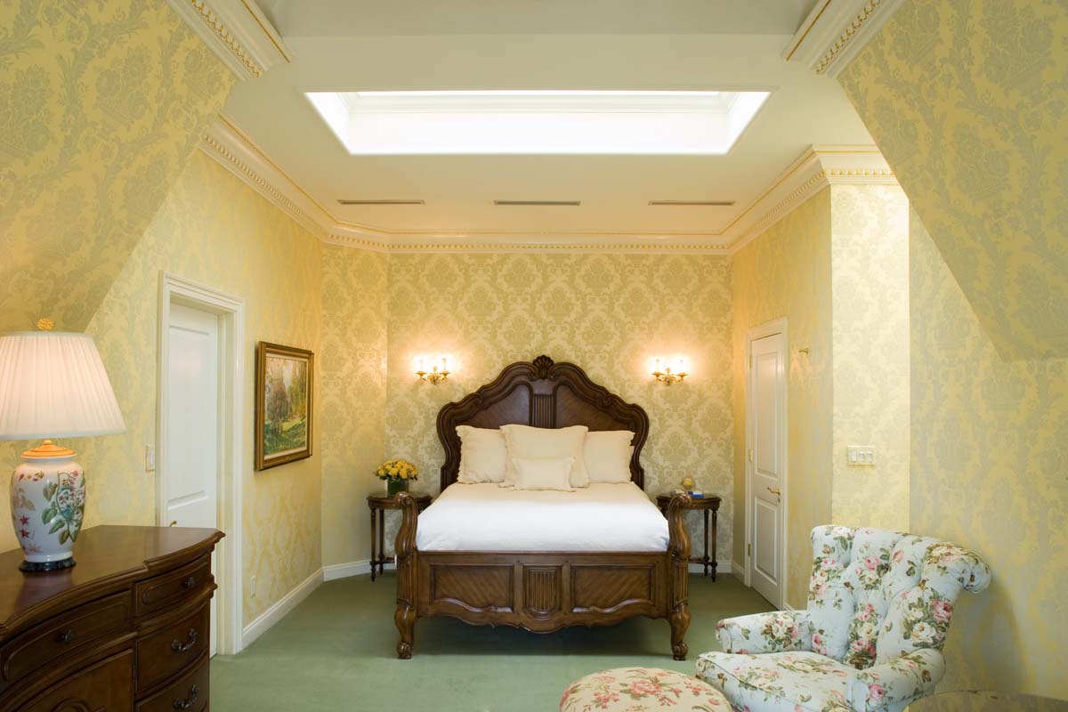 a bedroom with a bed and a chair
