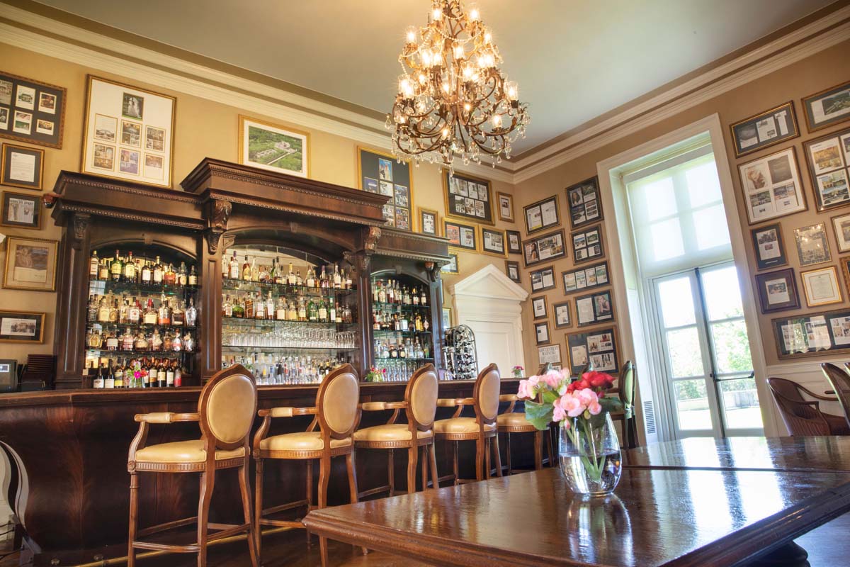 a room with a bar and a chandelier