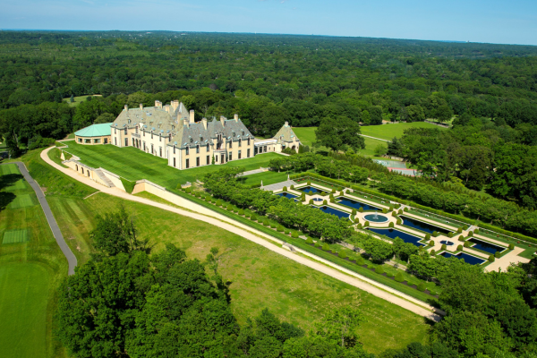 a large mansion with a large pool and trees