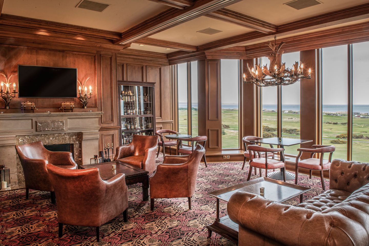 a room with a fireplace and chairs