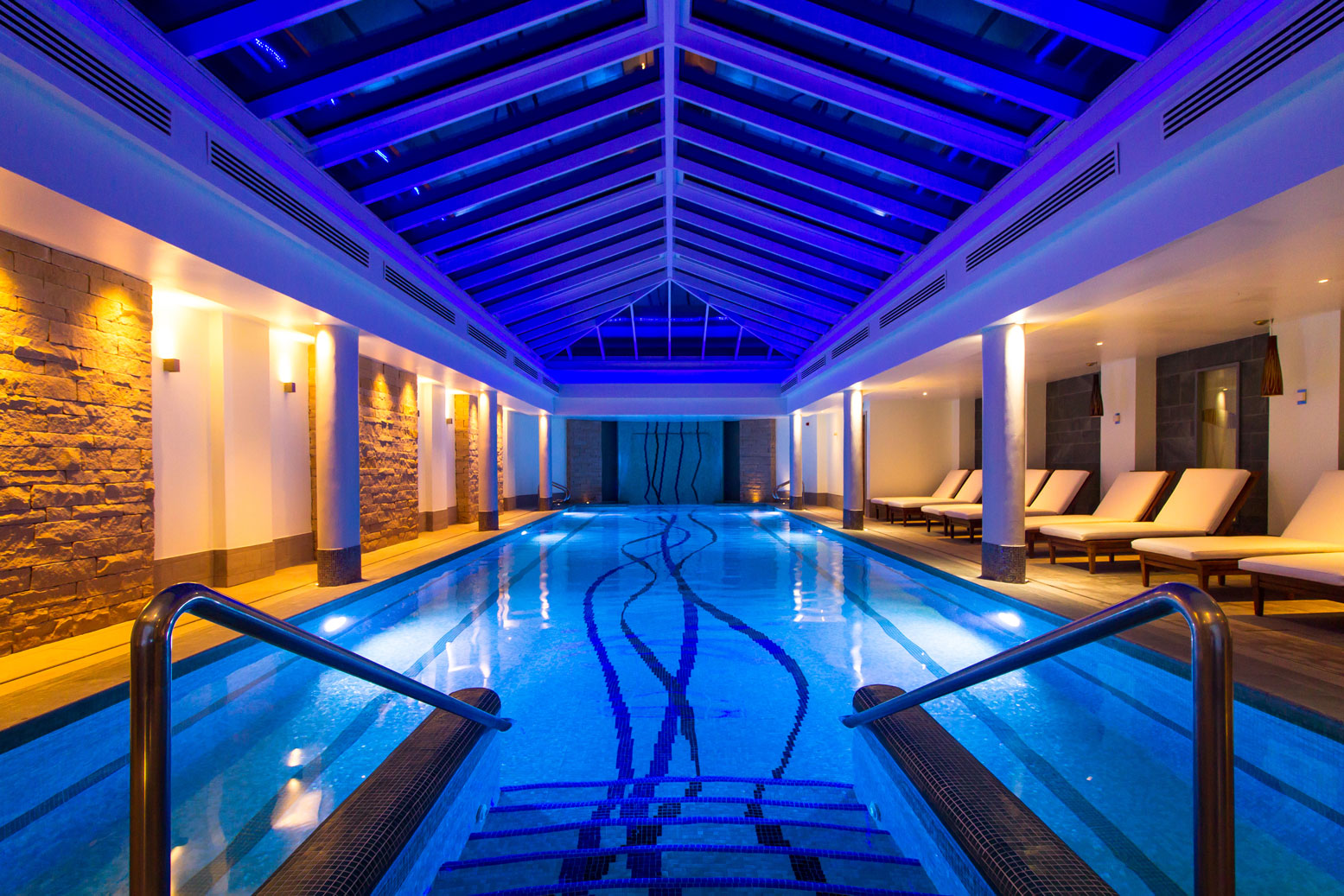 a indoor pool with a blue light