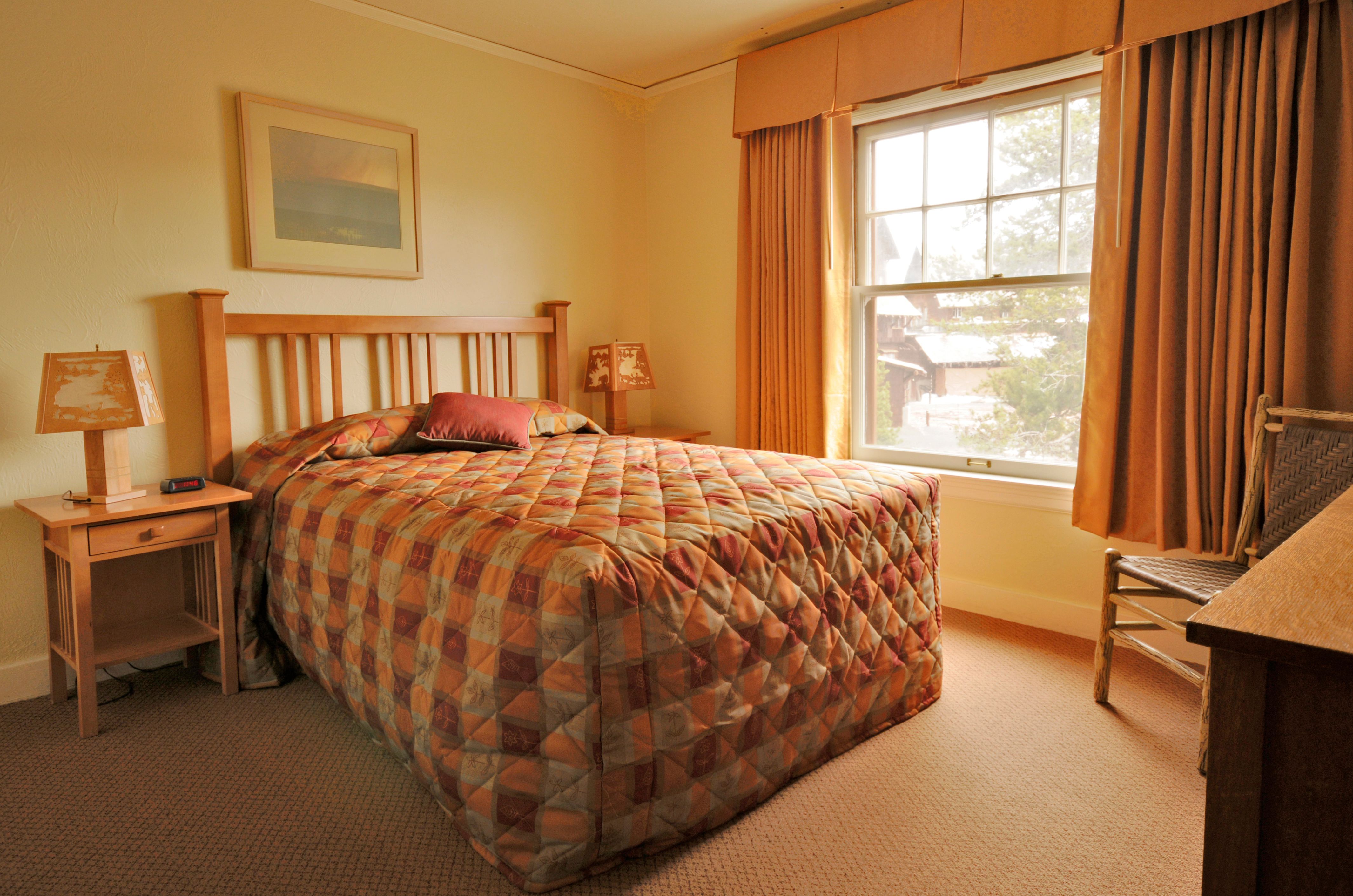 image of guestroom with queen bed old faithful inn yellowstone national park wyoming_high