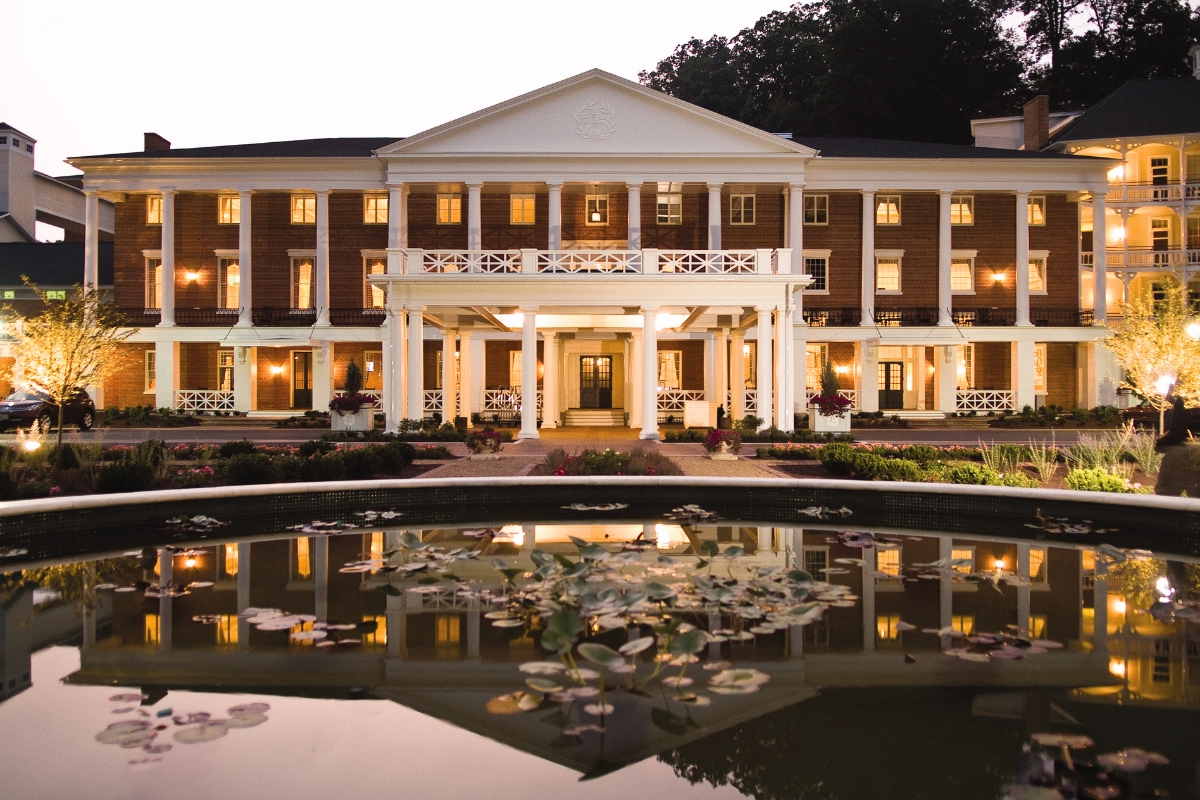 a large building with a pond in front of it