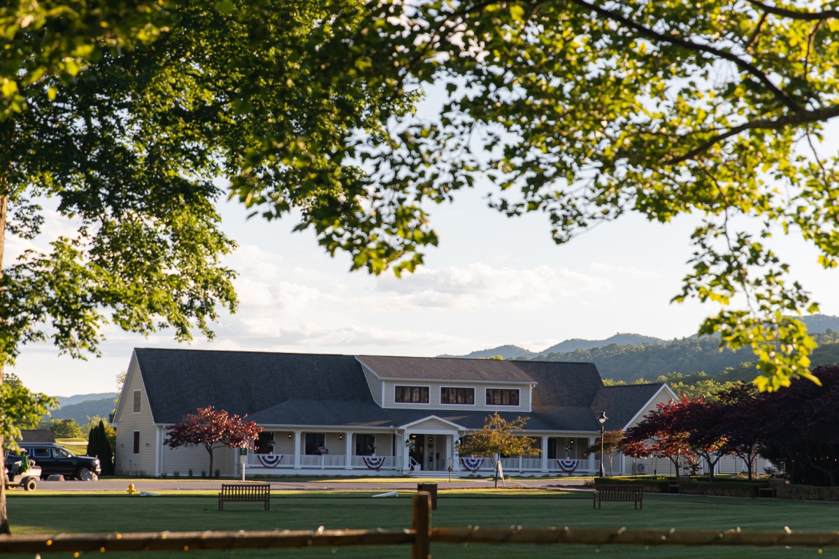 a building with a lawn and trees