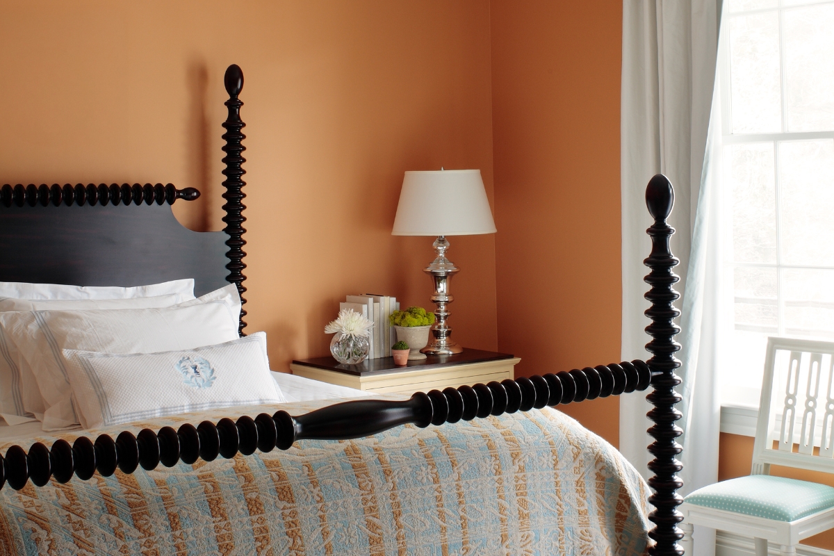 a bed with a lamp on a table